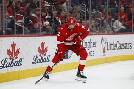 Nov 18, 2025; Detroit, Michigan, USA; Detroit Red Wings defenseman Travis Hamonic (52) skates with the puck in the first period against the Seattle Kraken at Little Caesars Arena.