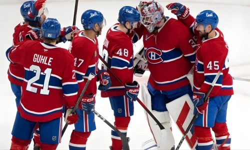 Montreal Canadiens players surround goaltender Sam Montembeault (35) Montreal Canadiens players surround goaltender Sam Montembeault (35)