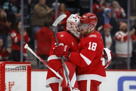Nov 18, 2025; Detroit, Michigan, USA; Detroit Red Wings goaltender Cam Talbot (39) and Detroit Red Wings center Andrew Copp (18) celebrate defeating the Seattle Kraken at Little Caesars Arena.