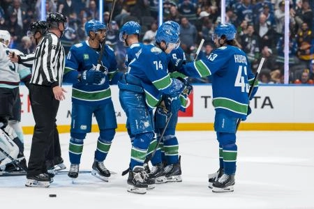 Evander Kane, Elias Pettersson, Brock Boeser, Jake DeBrusk and Quinn Hughes celebrating a goal during the preseason.