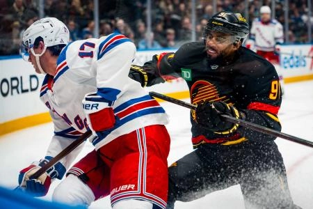 Oct 28, 2025; Vancouver, British Columbia, CAN; Vancouver Canucks forward Evander Kane (91) checks New York Rangers defenseman Will Borgen (17) in the second period at Rogers Arena. Mandatory Credit: Bob Frid-Imagn Images