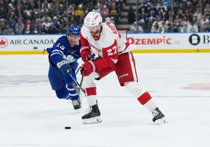 Oct 2, 2025; Toronto, Ontario, CAN; Toronto Maple Leafs left wing Matthew Knies (23) battles for the puck with Detroit Red Wings center Michael Rasmussen (27) during the second period at Scotiabank Arena.
