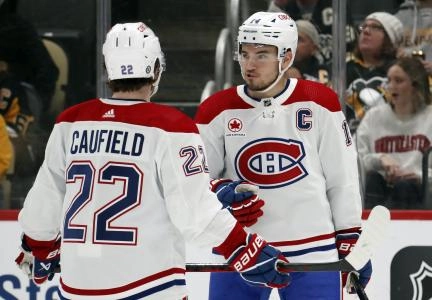 Feb 22, 2024; Pittsburgh, Pennsylvania, USA; Montreal Canadiens center Nick Suzuki (14) talks with Montreal Canadiens right wing Cole Caufield (22) against the Pittsburgh Penguins during the first period at PPG Paints Arena. Mandatory Credit: Charles LeClaire-Imagn Images