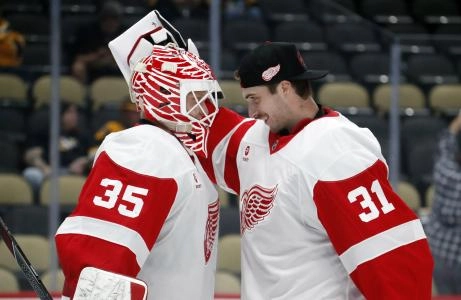Oct 1, 2024; Pittsburgh, Pennsylvania, USA; Detroit Red Wings goaltender Carter Gylander (31) congratulates goaltender Ville Husso (35) on his victory over the Pittsburgh Penguins at PPG Paints Arena. Detroit won 2-1.
