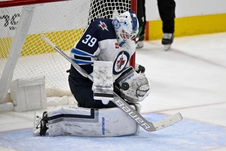 Apr 11, 2024; Dallas, Texas, USA; Winnipeg Jets goaltender Laurent Brossoit (39) makes a save on a Dallas Stars shot during the third period at the American Airlines Center. Mandatory Credit: Jerome Miron-Imagn Images