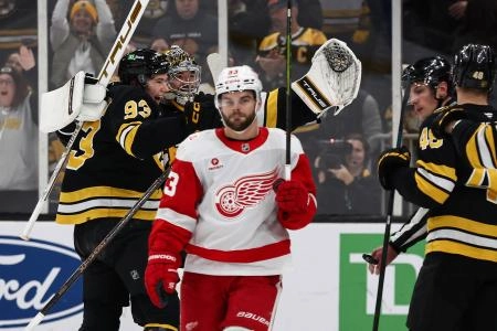 Nov 29, 2025; Boston, Massachusetts, USA; Detroit Red Wings right wing Alex Debrincat (93) skates away after being stopped on Detroit's last shootout attempt by Boston Bruins goaltender Jeremy Swayman (1) who celebrates with center Fraser Minten (93) at TD Garden.