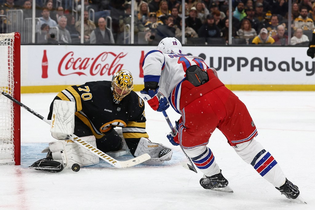 Boston Bruins goaltender Joonas Korpisalo (70) making a save as New York Rangers left wing Artemi Panarin (10) looks for the rebound.