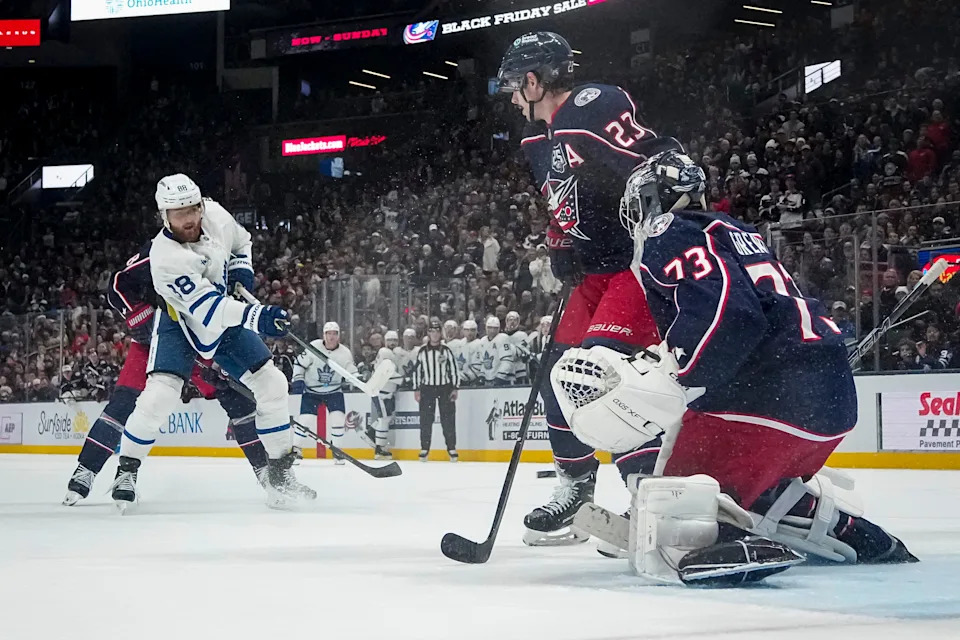 Toronto Maple Leafs right wing William Nylander (88) scores the game-winning goal in overtime past Columbus Blue Jackets center Sean Monahan (23) and goaltender Jet Greaves (73) during the NHL hockey game at Nationwide Arena in Columbus on Nov. 26, 2025. The Blue Jackets lost 2-1.