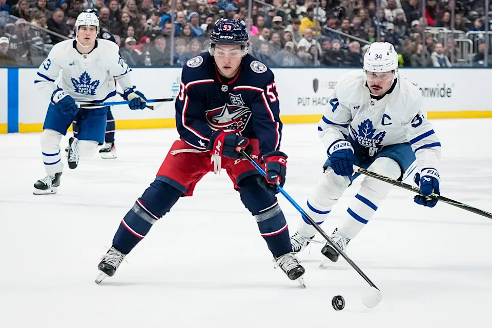 Columbus Blue Jackets center Luca Pinelli (53) skates by Toronto Maple Leafs center Auston Matthews (34) during the first period of the NHL hockey game at Nationwide Arena in Columbus on Nov. 26, 2025.