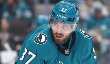 Sharks D hit by puck on bench