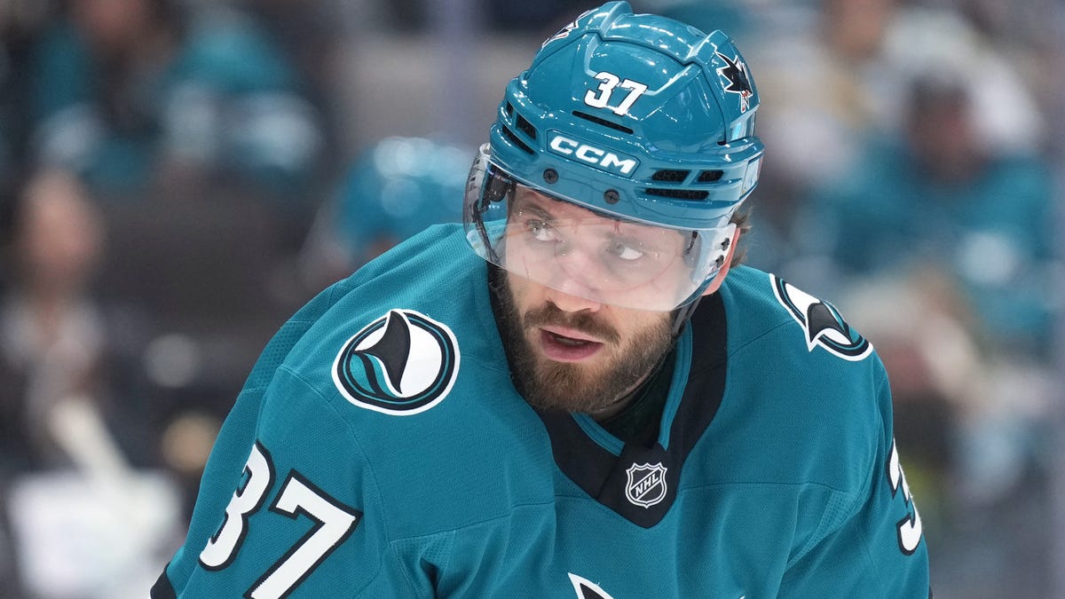 Sharks D hit by puck on bench