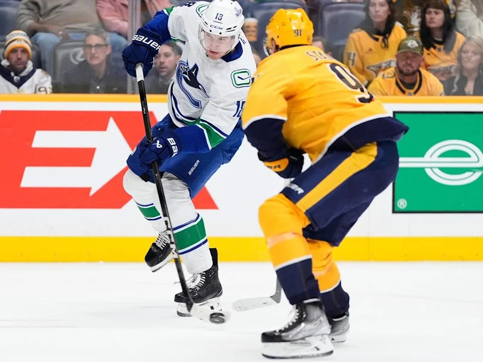  Canucks left winger Drew O’Connor shoots puck past Predators forward Steven Stamkos on Monday night.