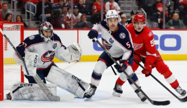 Nov 22, 2025; Detroit, Michigan, USA; Columbus Blue Jackets defenseman Denton Mateychuk (5) and Detroit Red Wings center Emmitt Finnie (58) fight for position in front of goaltender Jet Greaves (73) in the second period at Little Caesars Arena.