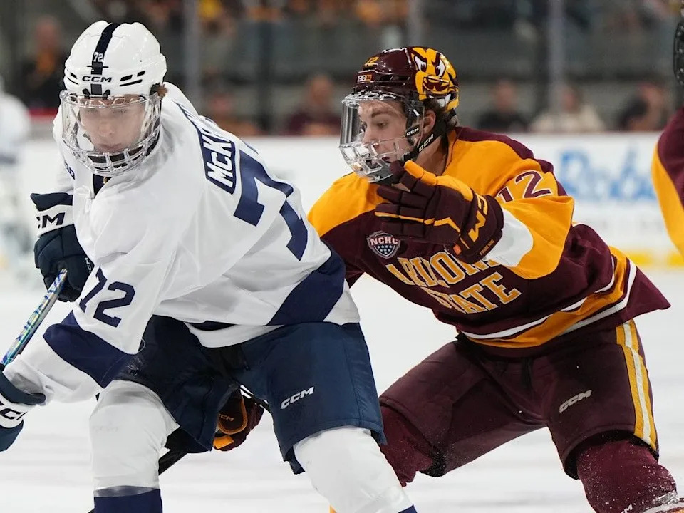 Calgary Flames prospect Cullen Potter, right, a sophomore with the Arizona State Sun Devils, checks Gavin McKenna of the Penn State Nittany Lions.