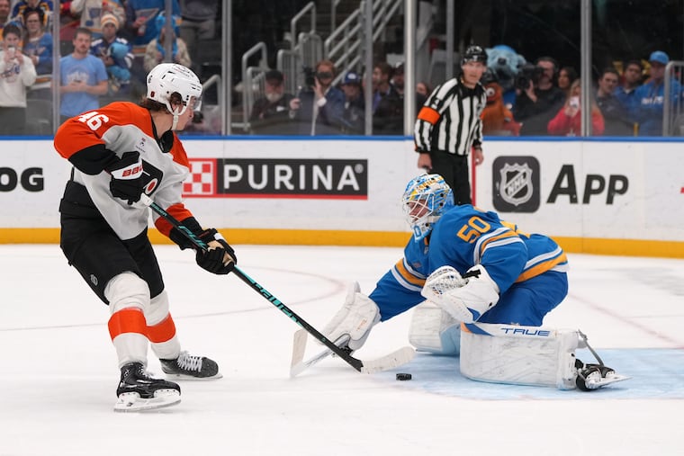 The Flyers' Trevor Zegras scores past St. Louis Blues goaltender Jordan Binnington during a shootout.