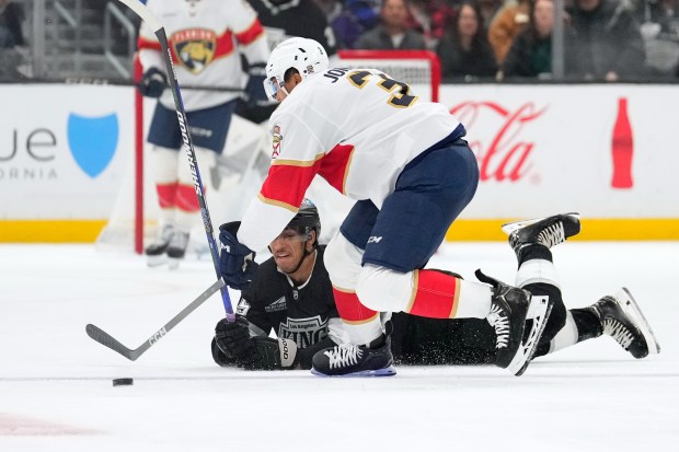 Kings right wing Quinton Byfield, below, falls as Florida Panthers...
