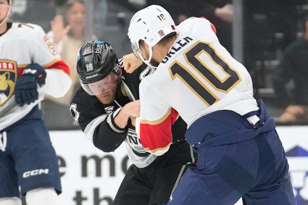 Kings right wing Corey Perry, left, fights with Florida Panthers...