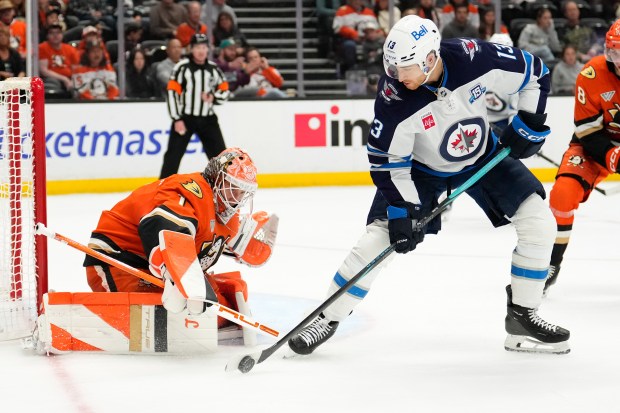 Winnipeg Jets center Gabriel Vilardi right, tries to get a...