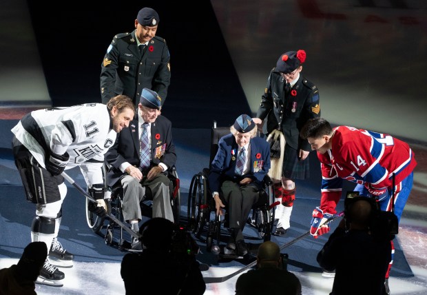 Veterans of World War II, Corporal Anne McNamara assisted by...
