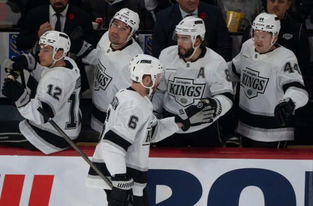 The Kings’ Joel Edmundson (6) celebrates his goal with teammates...