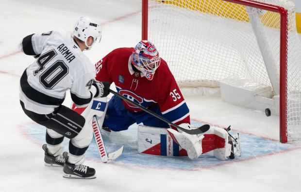 The Kings’ Joel Armia, left, scores past Montreal Canadiens goaltender...