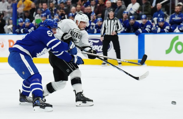 The Kings’ Kevin Fiala, right, shoots as the Toronto Maple...