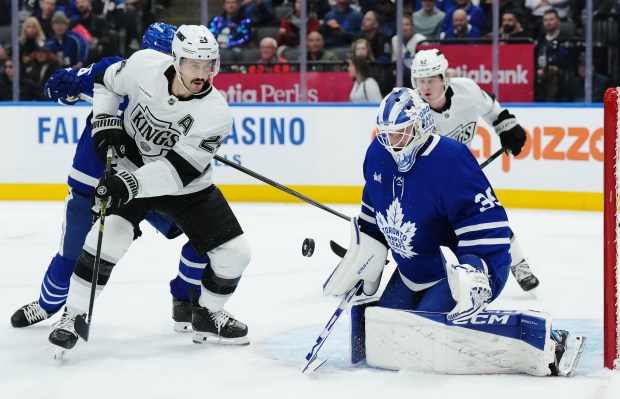 Toronto Maple Leafs goaltender Dennis Hildeby, right, makes a save...