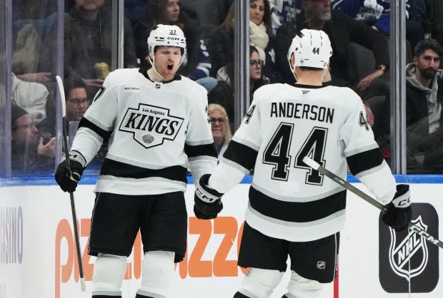 The Kings’ Warren Foegele, left, celebrates with Mikey Anderson after...