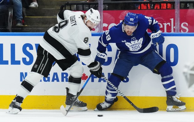 The Kings’ Drew Doughty, left, and the Toronto Maple Leafs’...