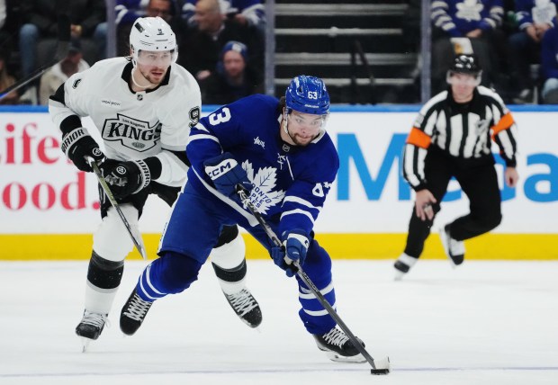 The Kings’ Adrian Kempe, left, chases the Toronto Maple Leafs’...