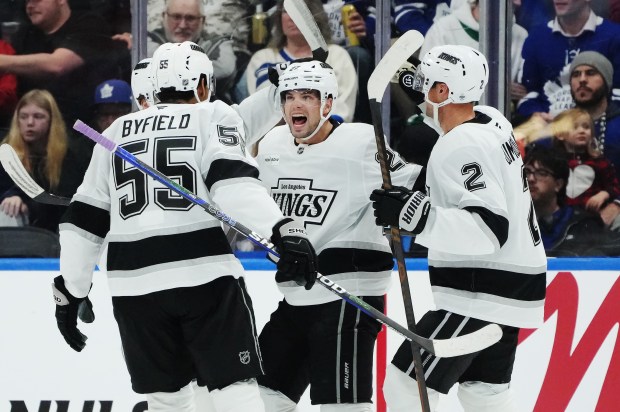 The Kings’ Kevin Fiala, center, celebrates his goal with Quinton...