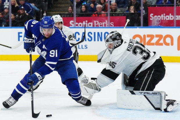The Toronto Maple Leafs’ John Tavares, left, prepares to score...