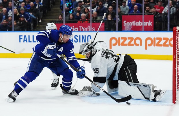 The Toronto Maple Leafs’ John Tavares, left, scores on Kings...
