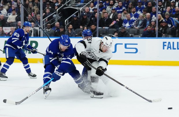 The Toronto Maple Leafs’ Morgan Rielly, left, battles with the...