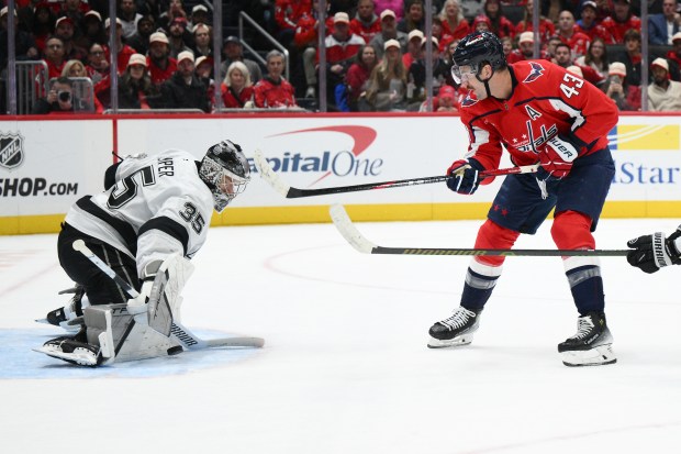Kings goaltender Darcy Kuemper, left, stops a shot by Washington...