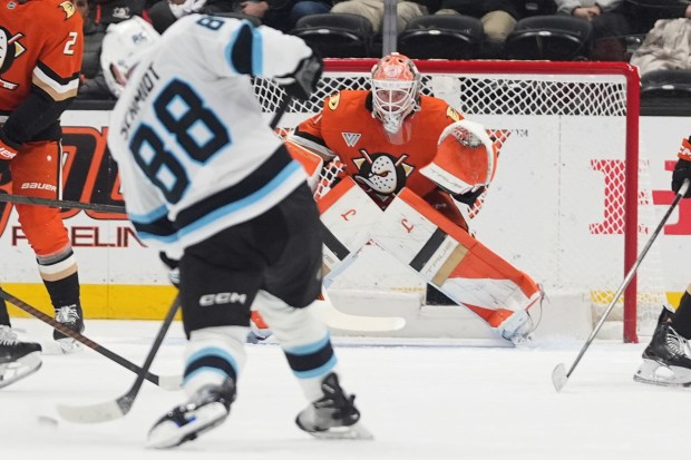 Ducks goaltender Lukas Dostal, center right, prepares for a shot...