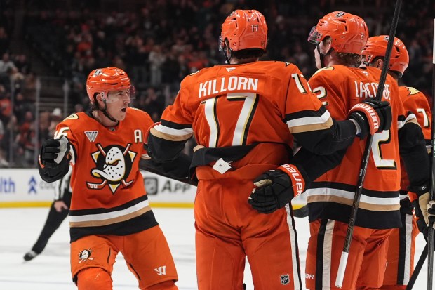 Ducks center Ryan Strome, left, celebrates with teammates after his...