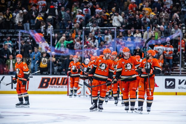 Ducks players celebrate after defeating the Boston Bruins, 4-3, on...