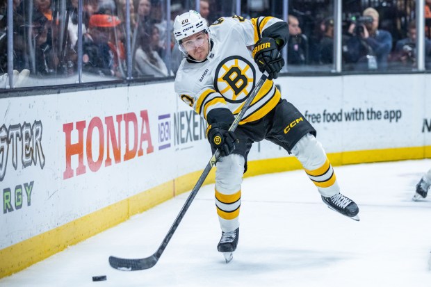 Boston Bruins defenseman Henri Jokiharju passes the puck during the...