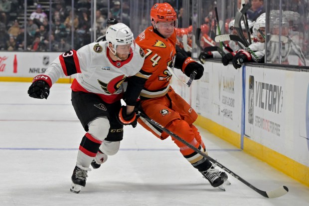 Ottawa Senators defenseman Nick Jensen, left, and Ducks defenseman Ian...