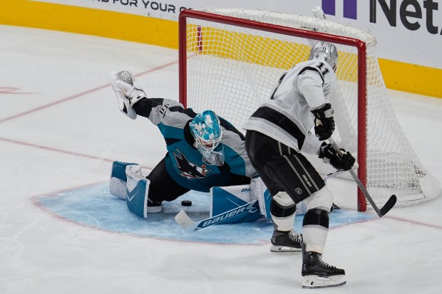 Kings center Anze Kopitar, right, scores a goal against San...