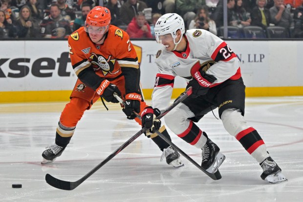 Ducks defenseman Jackson Lacombe, left, and Ottawa Senators center Dylan...