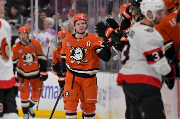 Ducks center Mason McTavish, center, is congratulated after scoring during...
