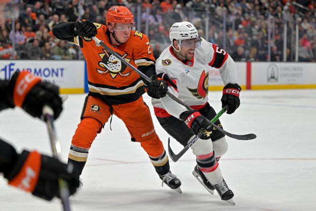 Ducks defenseman Jackson Lacombe, left, and Ottawa Senators left wing...