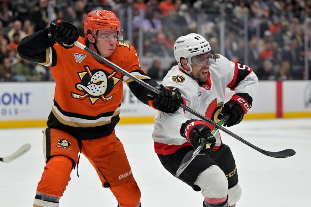 Ducks defenseman Jackson Lacombe, left, and Ottawa Senators left wing...