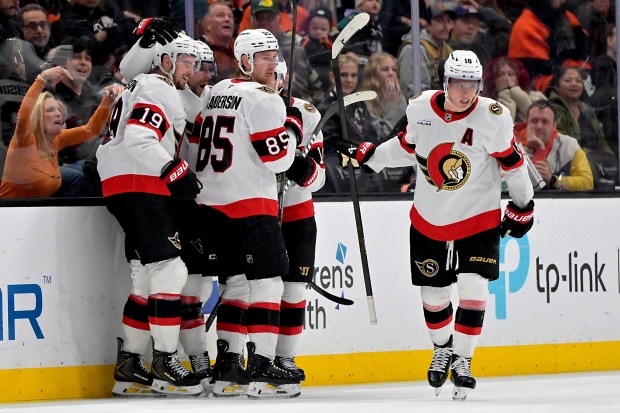 Ottawa Senators right wing Drake Batherson, left, is congratulated after...