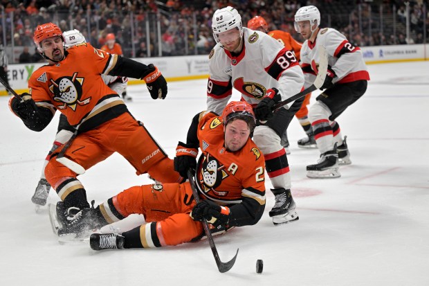 Ducks left wing Chris Kreider (20) gets tangled as the...