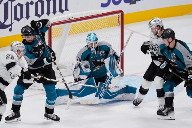 San Jose Sharks goaltender Yaroslav Askarov, center, deflects a shot...