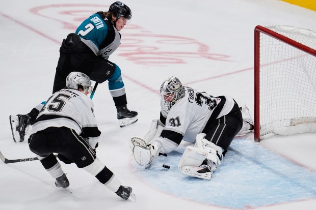 Kings goaltender Anton Forsberg, right, deflects a shot by San...