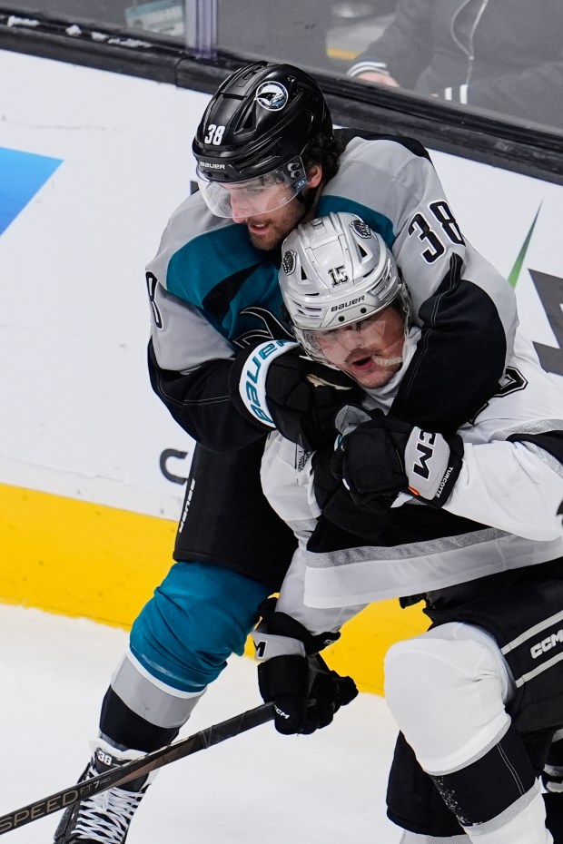 San Jose Sharks defenseman Mario Ferraro, top, and Kings center...